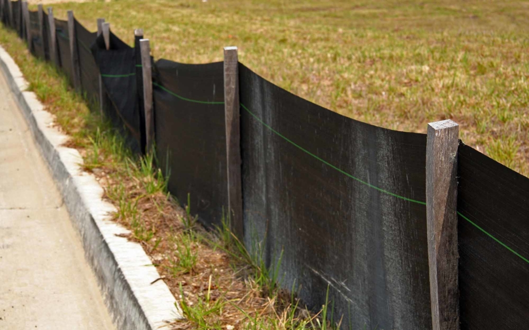 Black erosion barrier with wood stakes