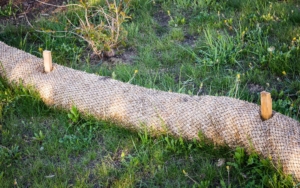 Erosion control straw barrier with wood spikes