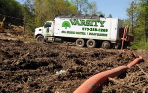 Varsity dirt truck sitting in a large clearing