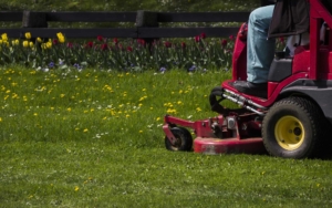 Commercial lawn mower working on cutting the grass