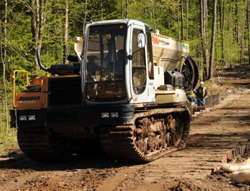 Varsity Workers On A Site With Large Machine 1030x644